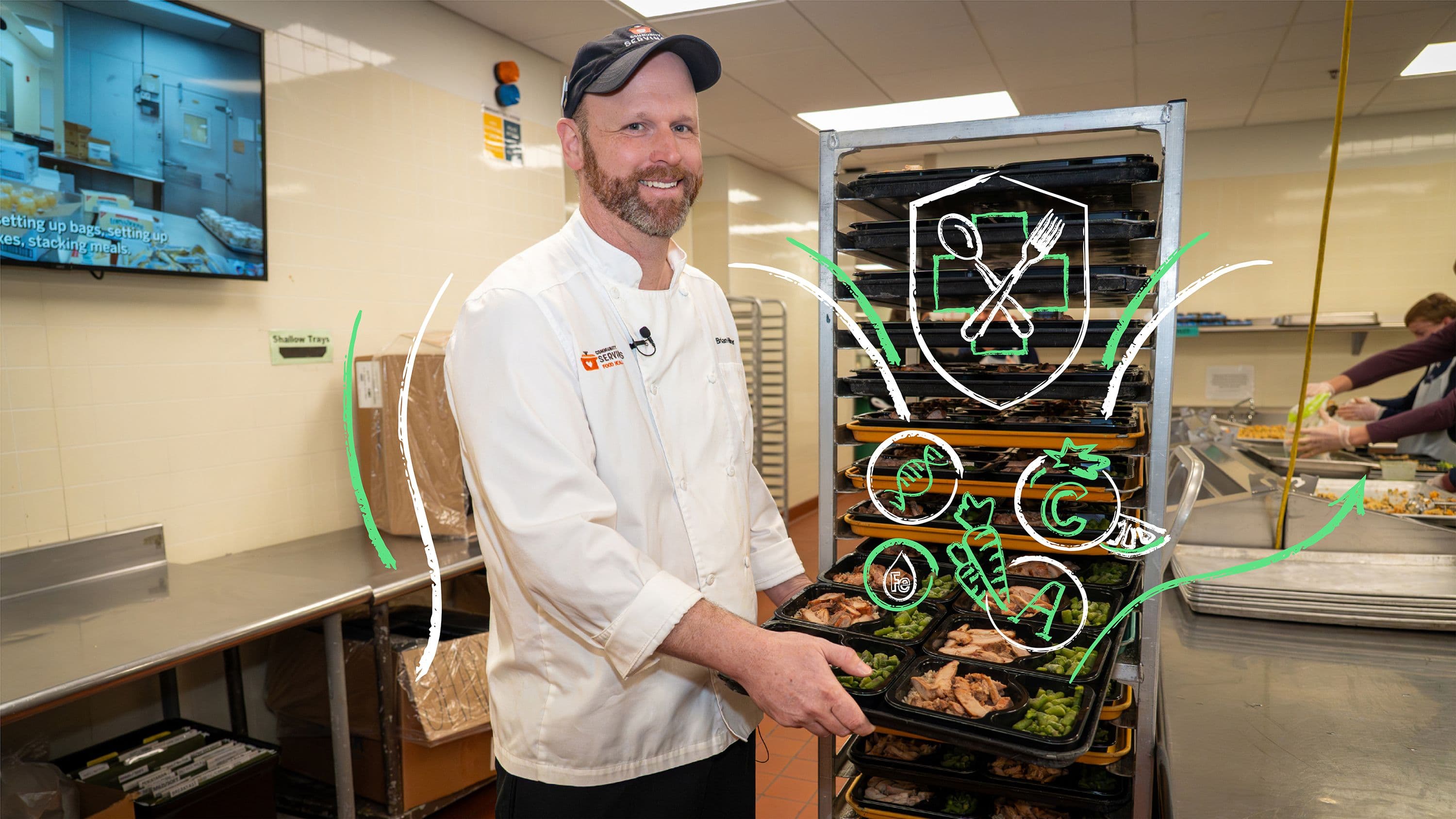 a chef in a commercial kitchen prepares trays of medically tailored meals beside a rolling rack of packaged food containers, with illustrated nutrition icons overlaid on the image.